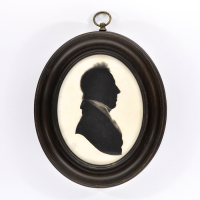 Front of silhouette, in frame, with man looking right.