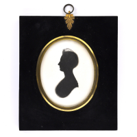Front of silhouette, in frame, with woman looking left.