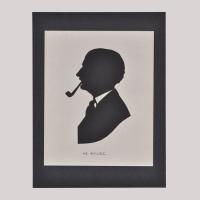 Silhouette of a man with pipe looking left