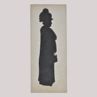 Silhouette of a woman in coat looking right