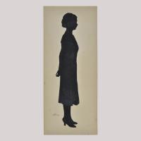 Silhouette of a woman in dress looking right