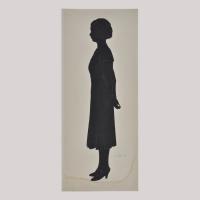 Silhouette of a woman in dress looking left