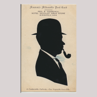 Front of silhouette, with man looking right, in suit wearing a hat and smooking a pipe. At the top inscription starting, Souvenir silhouete Post Card...