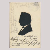 Front of silhouette, with man looking right, in suit, with german hand-written text.