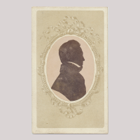 Front of silhouette, with man looking right, in painted frame.