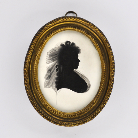 
        Front of silhouette, in frame, with woman looking right, with ribbon.