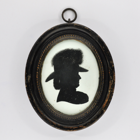 
        Front of Silhouette, in frame, with woman looking right and wearing a hat