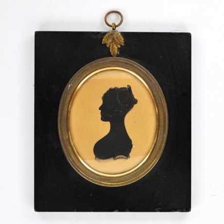 
        Front of silhouette, in frame, with woman looking left.