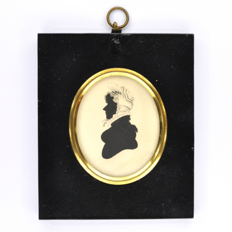 
        Front of silhouette, in frame, with woman looking left, wearing a bonnet.