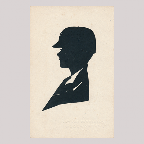 
        Front of silhouette, with boy looking left, wearing a hat.