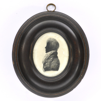 Front of silhouette, in frame, with man looking left, wearing a stock.