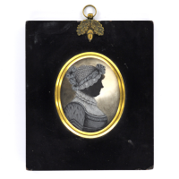 Front of silhouette, in frame, with woman looking right, wearing a bonnet.