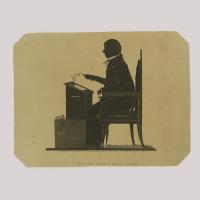 Silhouette of teacher/judge sitting in front of his desk, holding his glasses in his hand
