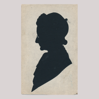 Front of silhouette, with man looking left, wearing a hat and glasses.