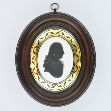 
        Front of silhouette, in frame, with man looking right.