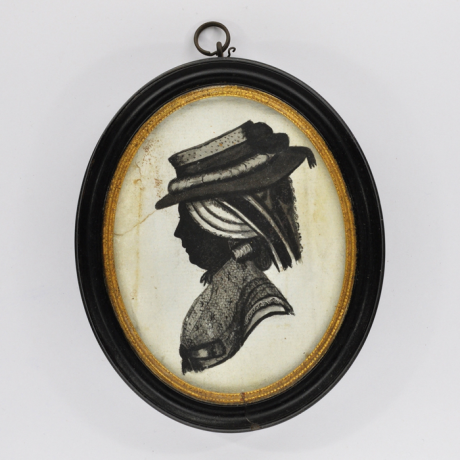 
        Front of Silhouette, in frame, with woman looking left and wearing a hat