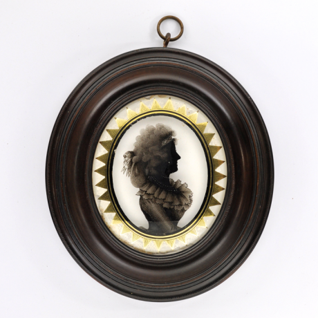
        Front of Silhouette, in frame, with woman looking right and wearing a ribbon