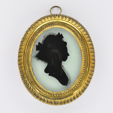 
        Front of Silhouette, in frame, with woman looking right and wearing a hat decorated with ribbons