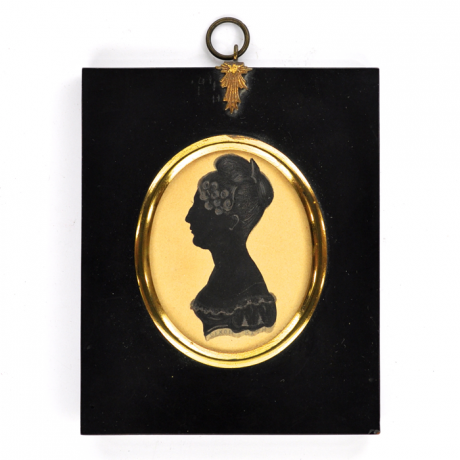 
        Front of silhouette, in frame, with woman looking left.