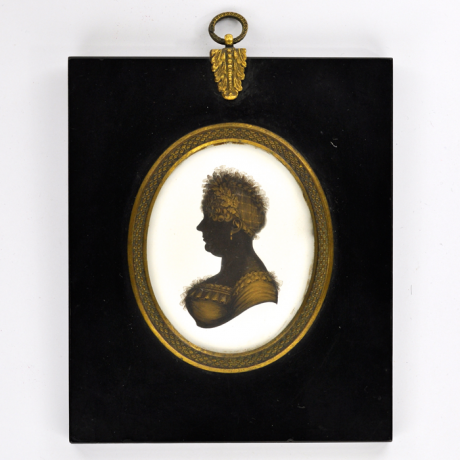 
        Front of silhouette, in frame, with woman looking left.