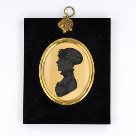 
        Front of silhouette, in frame, with woman looking left, wearing net hat.