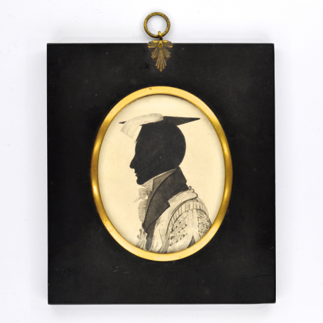 
        Front of Silhouette, in frame, with man looking left and wearing an academic clothes 