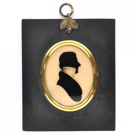 
        Front of silhouette, in frame, with man looking right, wearing a high necked collar.