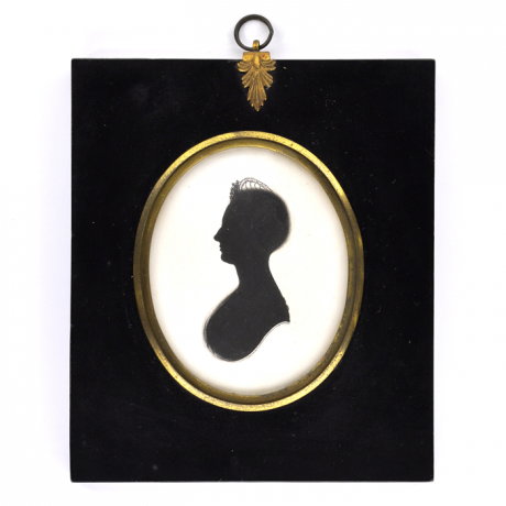 
        Front of silhouette, in frame, with woman looking left.
