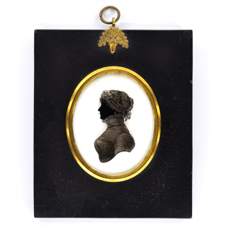
        Front of silhouette, in frame, with woman looking left, wearing a bonnet with ribbon.