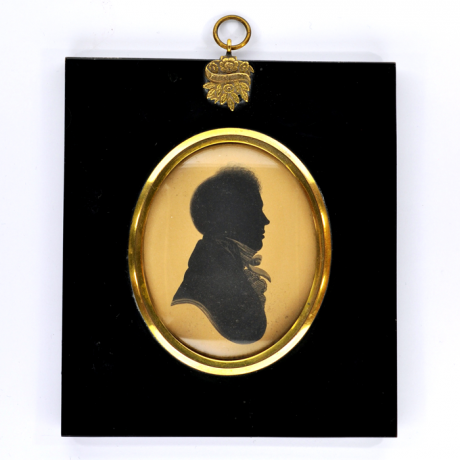 
        Front of silhouette, in frame, with man looking right, wearing a stock.
