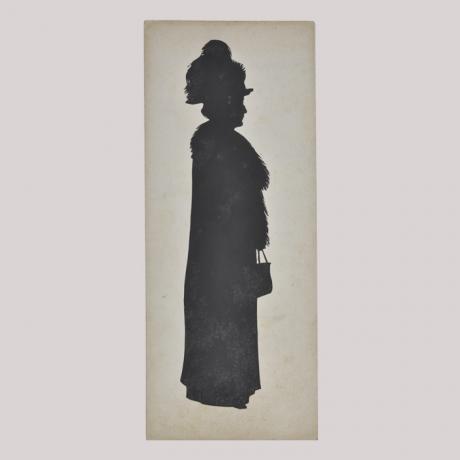 
        Silhouette of a woman in coat looking right