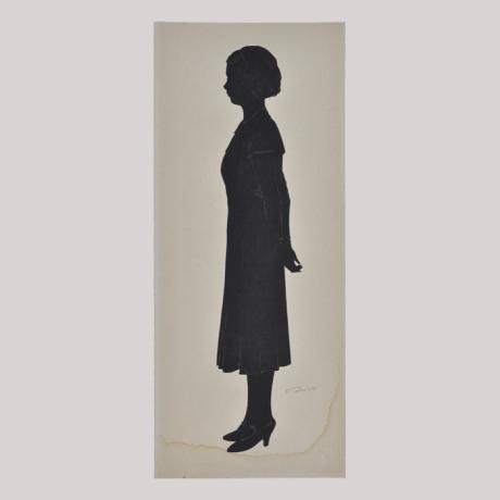 
        Silhouette of a woman in dress looking left