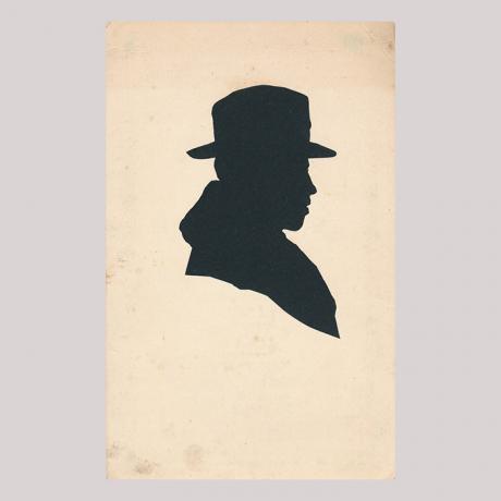 
        Front of silhouette, with man looking right, wearing a hat.