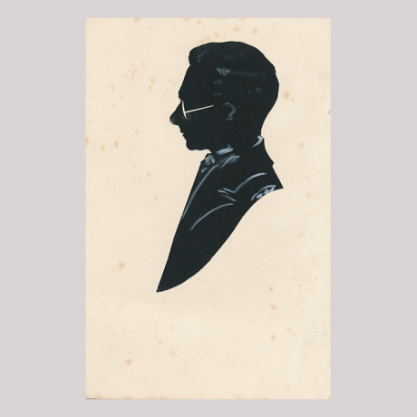 
        Front of silhouette, with man looking left, wearing glasses.