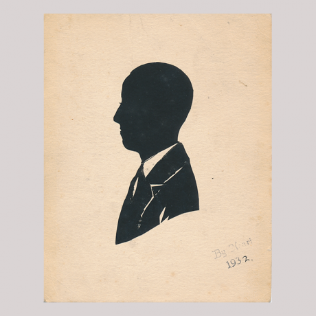 
        Front of silhouette, with man looking left, wearing a suit.