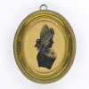 Front of silhouette, in frame, with woman looking right, wearing a ribbon.