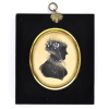 Front of Silhouette, in frame, with woman looking right and wearing a bonnet decorated with ribbons
